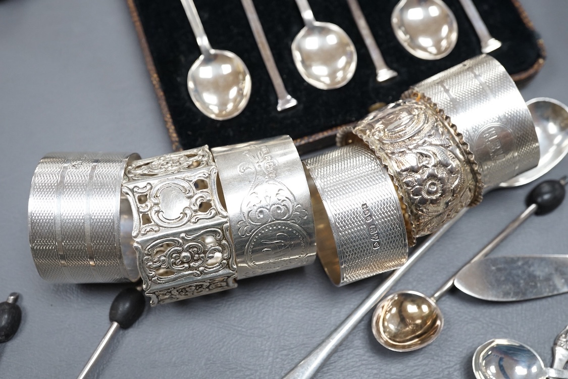Four assorted silver napkin rings, two cased sets of six silver spoons, four silver condiments including a pair, a small group of sundry flatware, a silver wine label and a plated napkin ring.